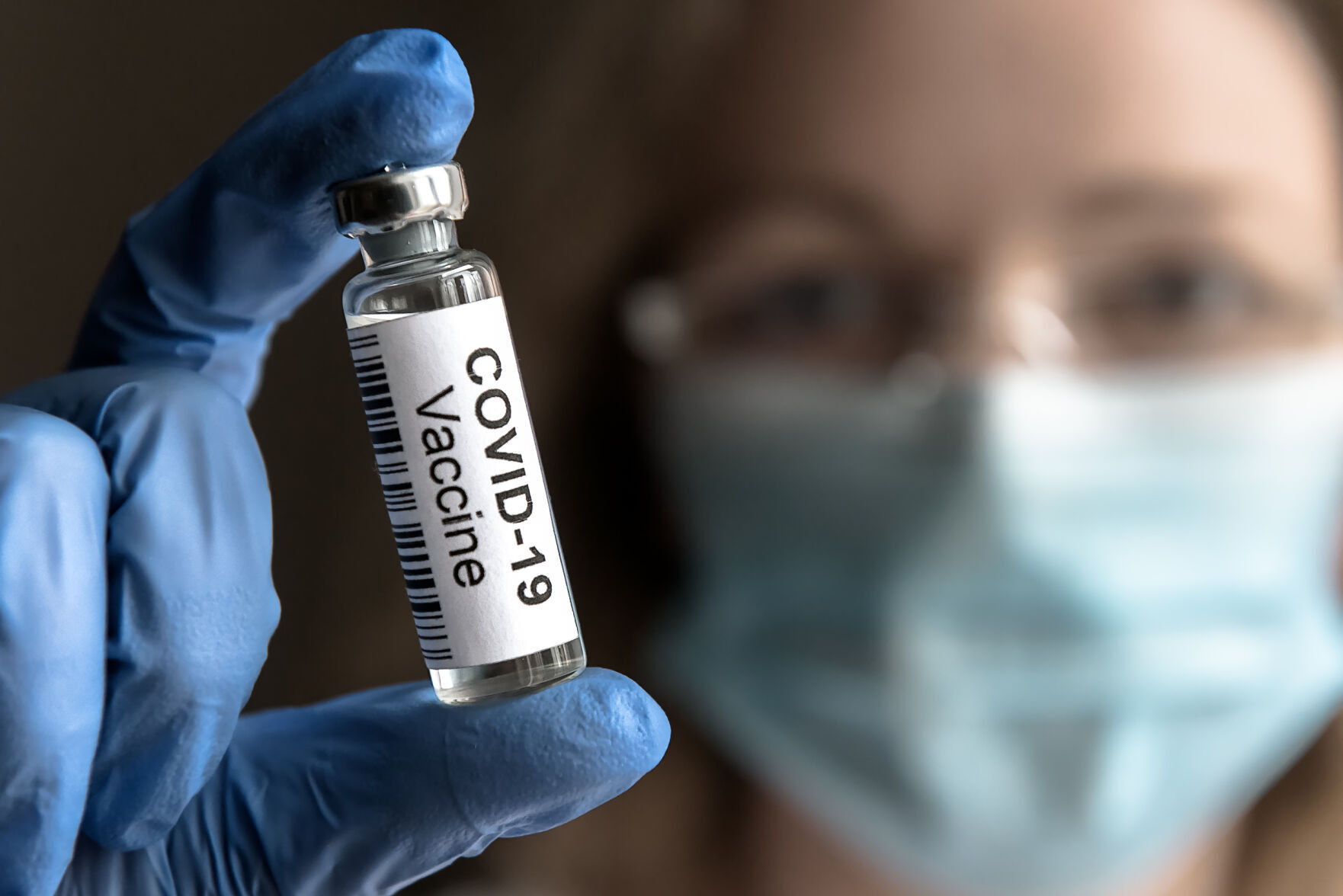 COVID-19 vaccine in doctor’s hand close-up